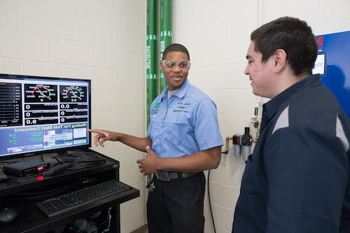 Professor Andrew McGee trains a student.